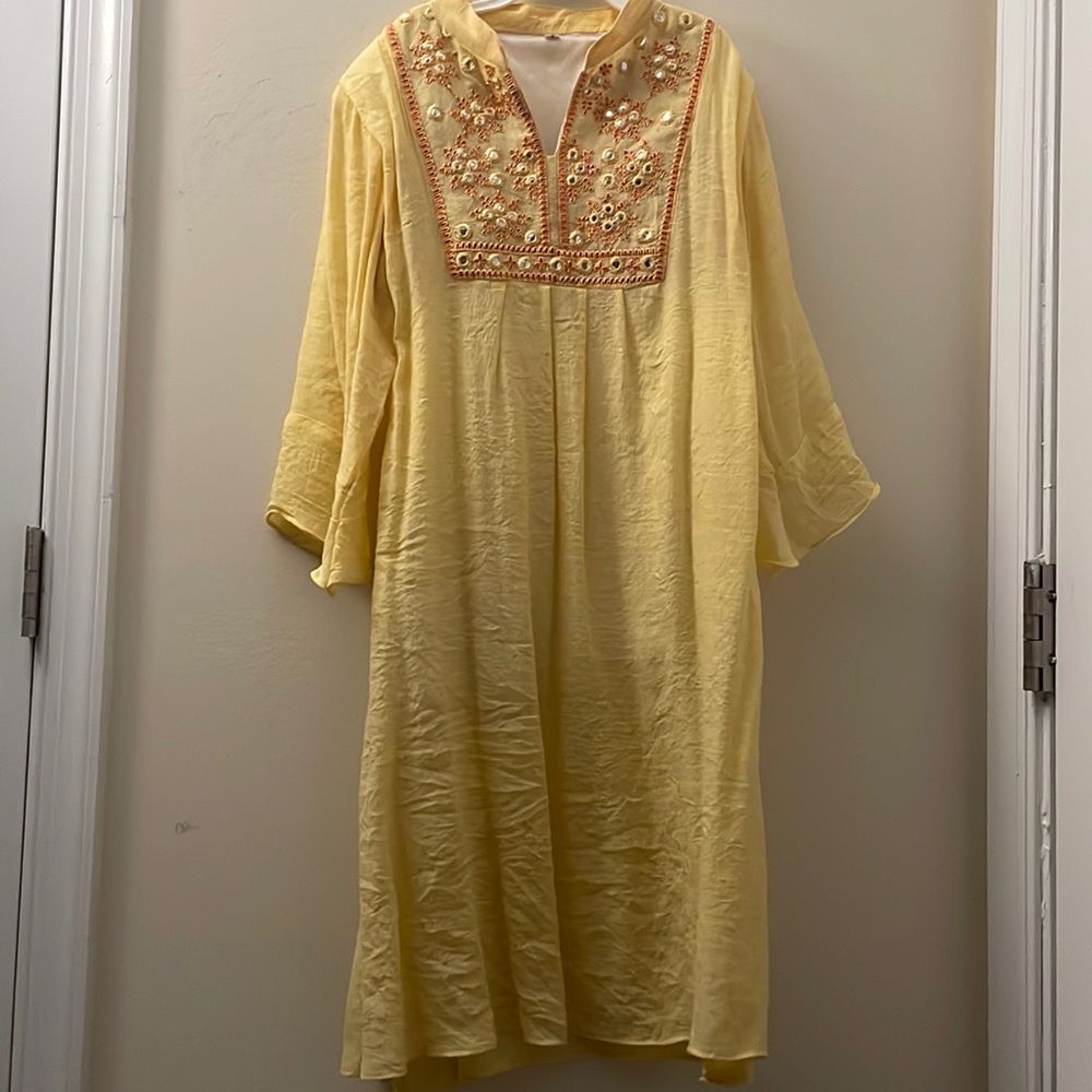 Yellow dress, with sequins around chest.